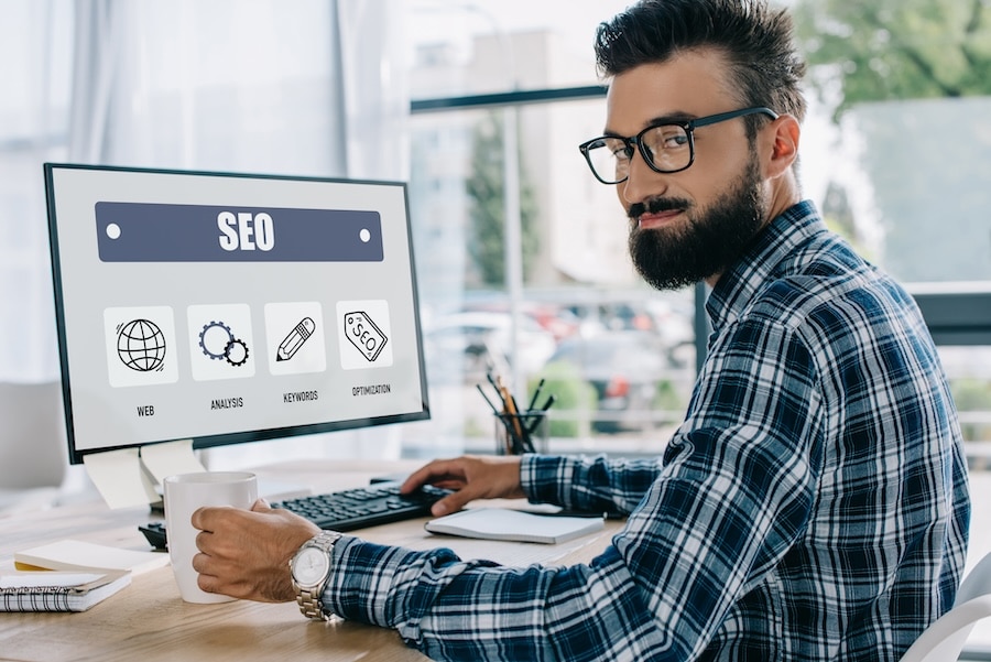 E-E-A-T SEO Manager Sitting At Desk