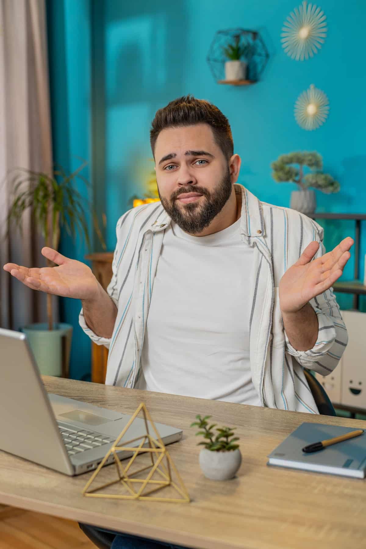 Confused man feeling embarrassed about ambiguous question having doubts no idea at home